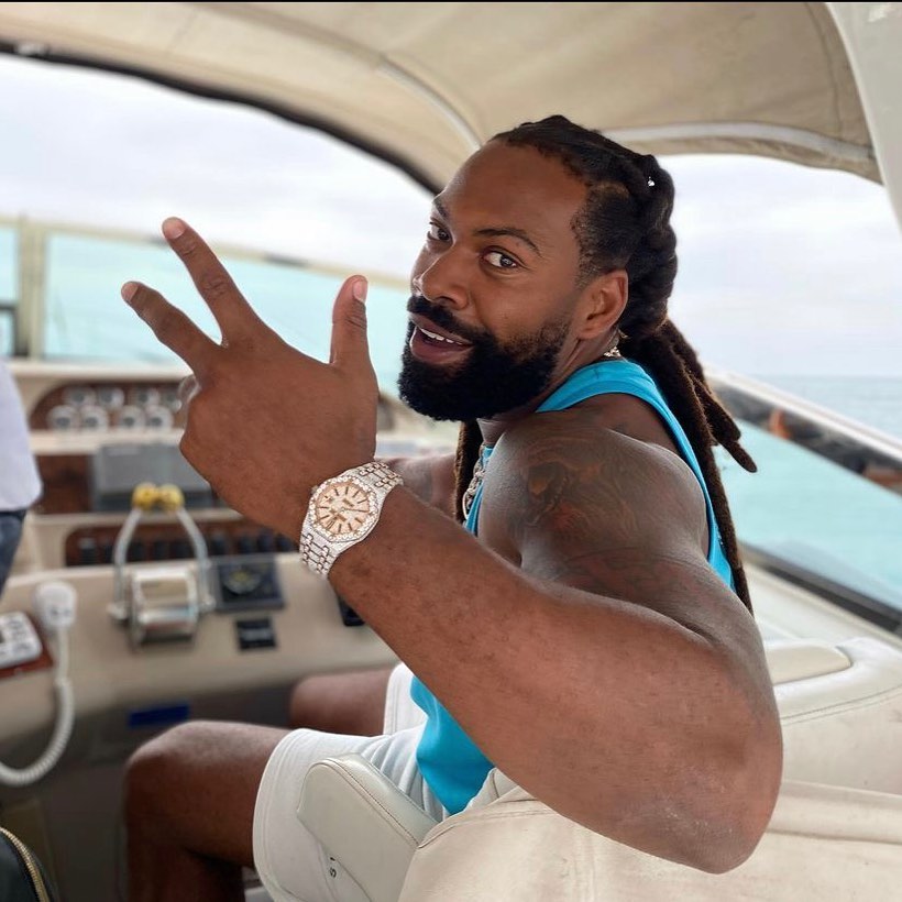 Kash Doll riding a jet ski in neon swimwear—previewing her rumored line