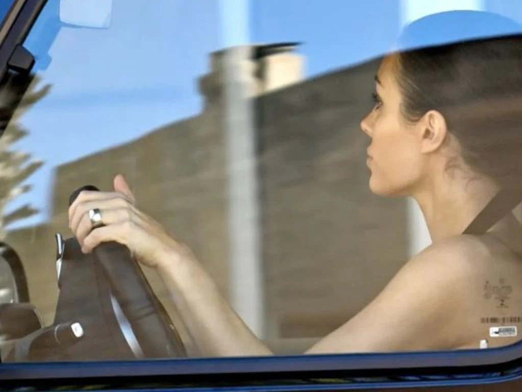 Censori entering The Balance clinic gates, recovery coach beside her