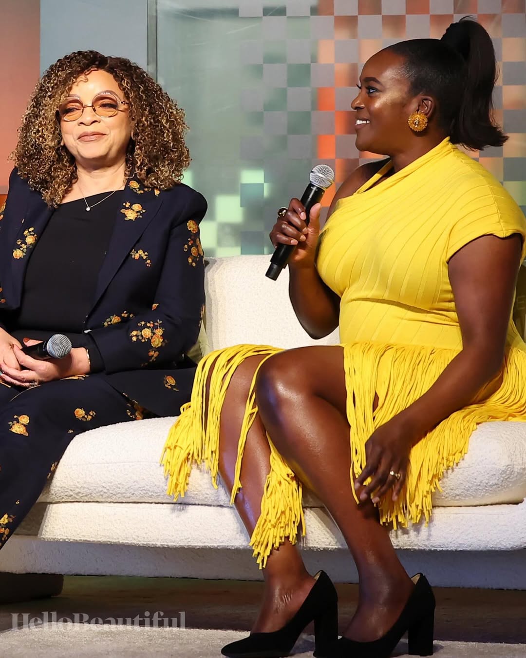 Wunmi Mosaku and Ruth E. Carter flanking a ‘Sinners’ banner on red carpet